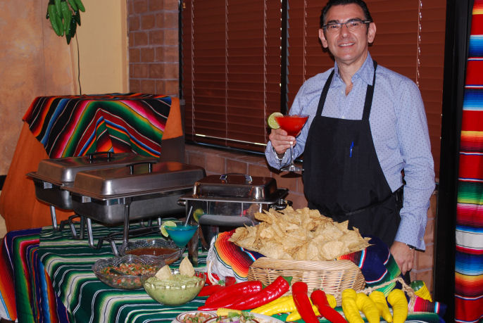 Our buffet table is always decorated with colorful Mexican serapes and 